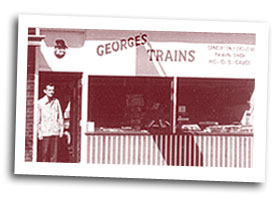 George in front of his original storefront